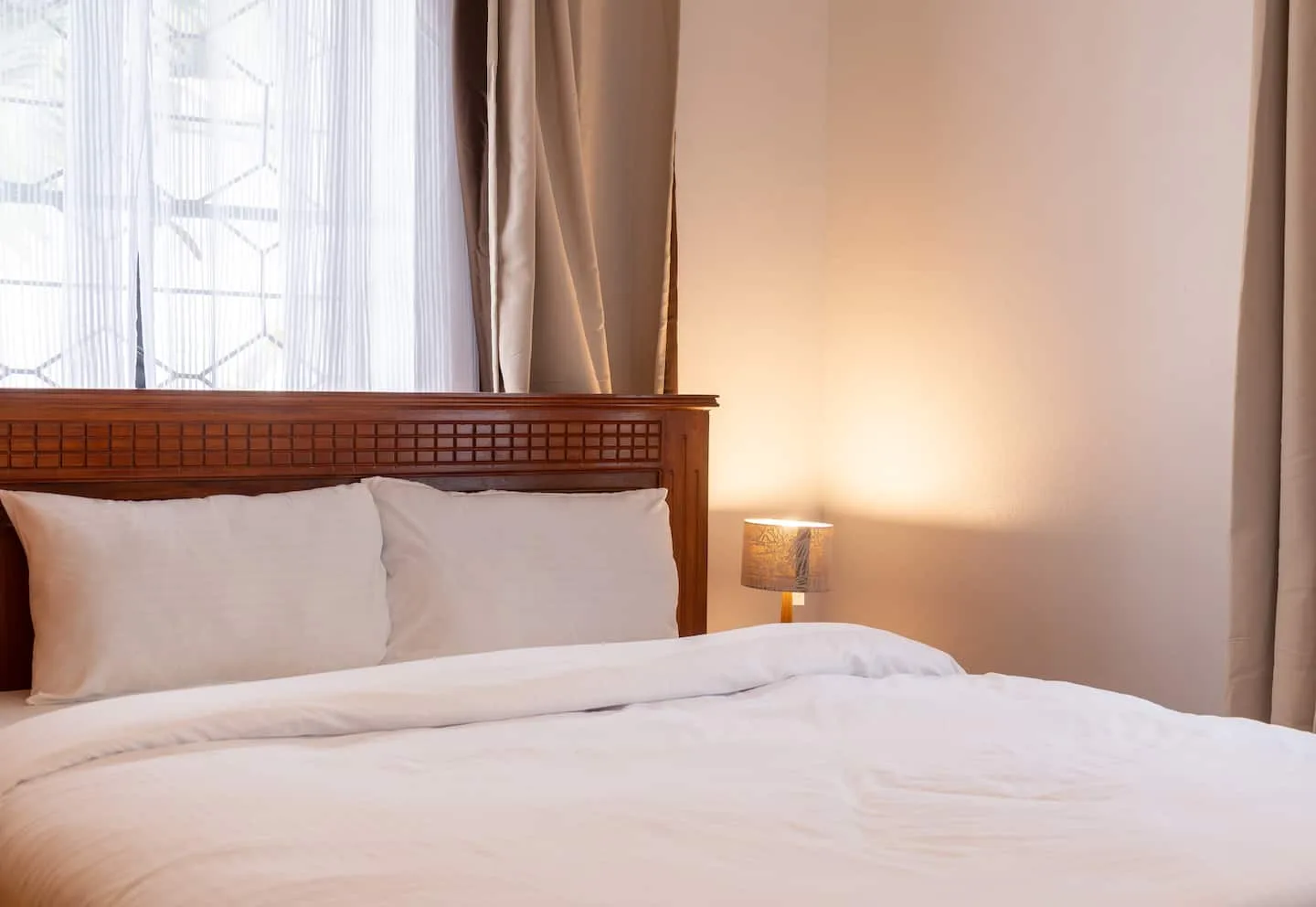 Main bedroom with a large bed and quality white linens