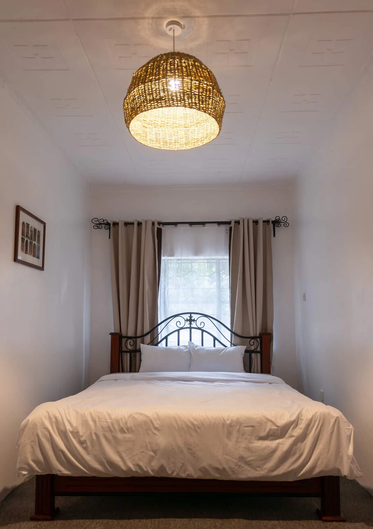 Second bedroom with a comfortable bed and bright window