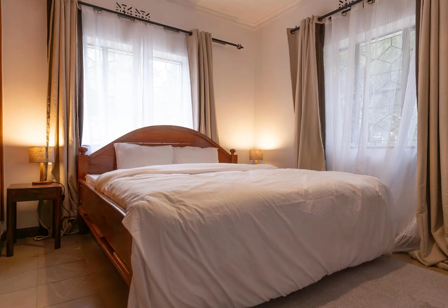 Third bedroom with a neatly made bed and warm tones